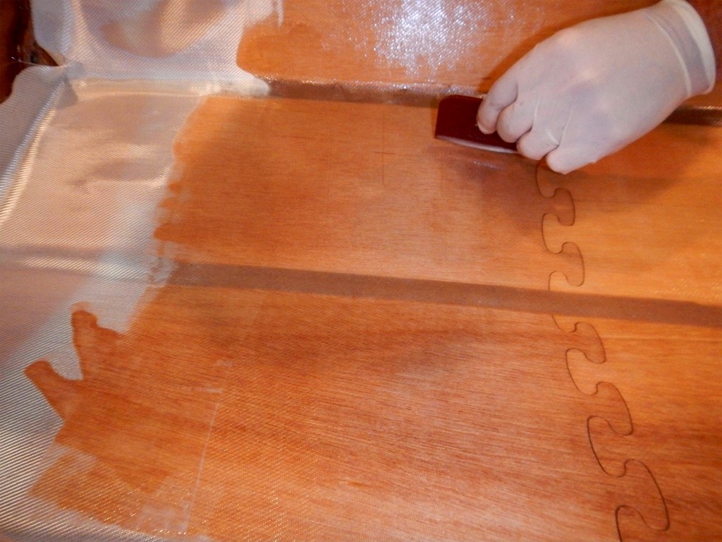 L'époxy rend le tissu transparent et fait reparaitre les joints entre les panneaux et les joints-puzzle des panneaux de fond. 