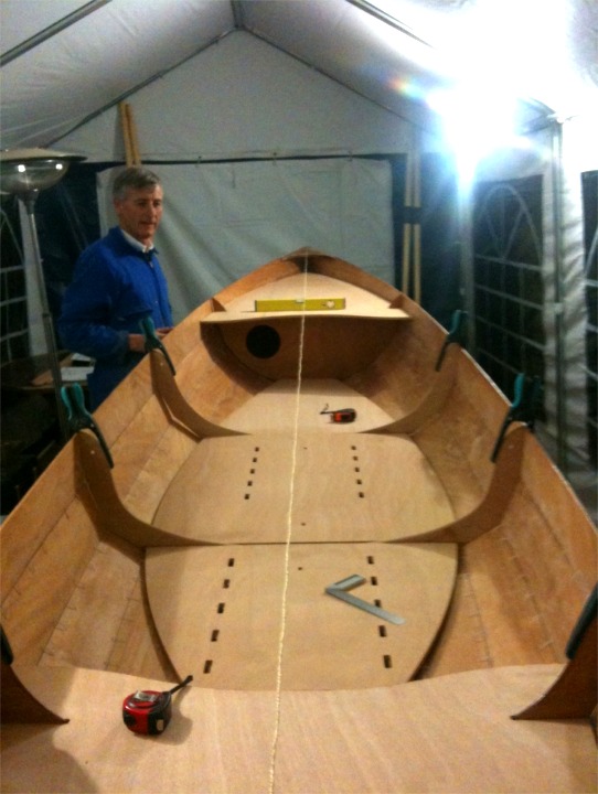 Cette image de l'intérieur de la Yole de Chester d'Hervé montre l'originalité de ce bateau bien mieux qu'un long discours (que je vous fais quand-même subir) : les deux membrures "tiennent" le centre de la coque et permettent d'éviter les traditionnels bancs transversaux. Le ou les nageurs (la Yole peut être nagée en double, en aviron traditionnel, sans coulisse) sont assis sur des tabourets mobiles, et un cale-pieds se coince dans les encoches des planchers pour le nageur avant ou unique, le nageur arrière se cale sur la cloison arrière. 