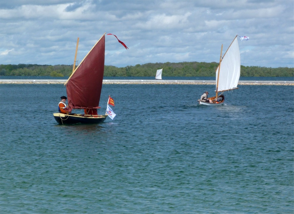 Retour de Cotentin, avec deux ris, et départ de La Marie Pupuce avec un seul. On aperçoit la voile de Piff derrière la jetée. 