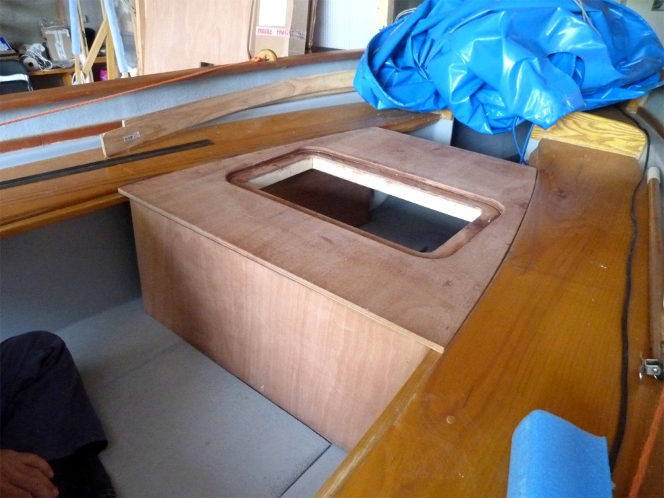 Et voici le panneau vertical arrière du coffre en place. Ce coffre a deux fonctions : outre le stockage au sec de duvets, habits et autres denrées sèches, il doit former une partie de la plateforme sur laquelle Pierre posera une petite tente à deux places qui lui permet de dormir à bord. Cette seconde fonction suppose que la surface du coffre ne présente pas d'aspérités qui réduiraient le confort des dormeurs (voir La Princesse au Petit Pois), c'est pourquoi nous avons surbaissé le seuil de la trappe étanche.