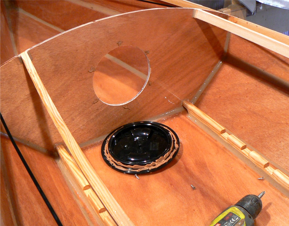 Pendant que l'époxy de la stratification du pont commence à "prendre", je monte les trappes à joint torique des compartiments étanches. J'ai déjà verni l'intérieur du cockpit, et cette opération termine l'aménagement de l'intérieur, qui sera très bientôt nettement moins accessible. 