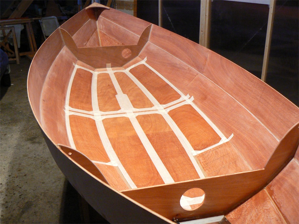 Je continue à profiter de l'accessibilité de l'intérieur de la coque du Skerry, pendant que je n'ai pas encore collé la membrure centrale : j'ai collé de l'adhésif de masquage pour délimiter les zones sur lesquelles je vais faire de l'antidérapant : une couche d'époxy fraiche, que je saupoudre de microsphères de verre (les pantoufles, c'est Cendrillon !) 