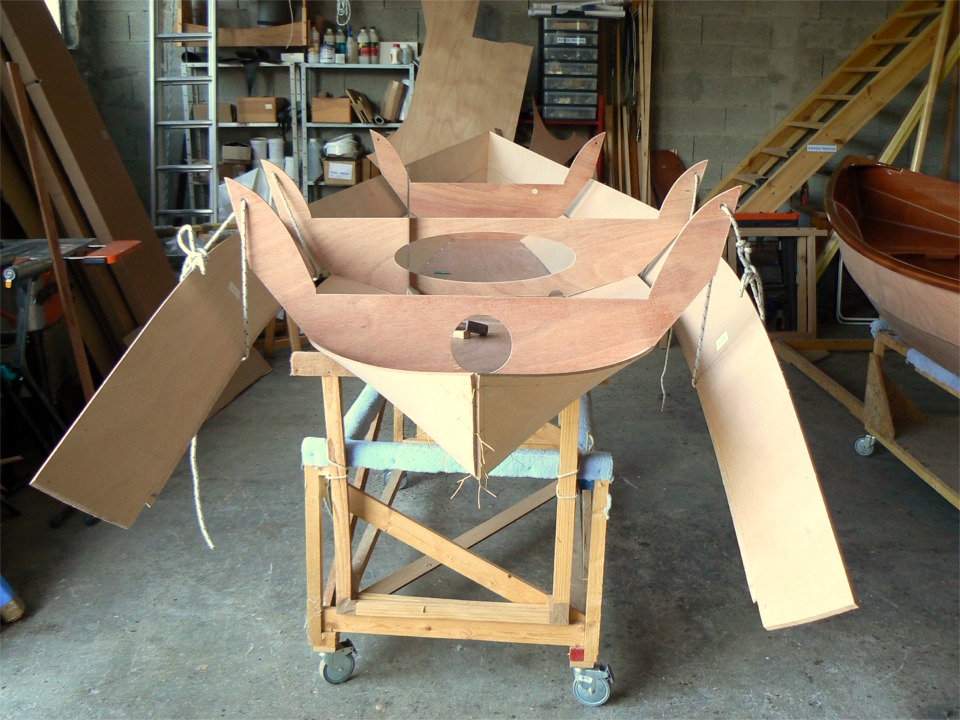 Contrairement à la pieuvre, je n'ai que deux mains et une intelligence ordinaire, et je me sers des membrures pour maintenir les bordés pendant que je les suture. Je commence par suspendre les bordés à la membrure centrale, puis à la membrure arrière, et je les suture tous deux ensemble sur l'étrave, puis aux bordés 1, en suturant en alternance d'un bord sur l'autre jusqu'à l'étambot. 