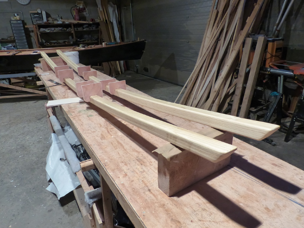 Apr&egrave;s le collage &agrave; l'&eacute;poxy des 8 plis de sapin de 6 mm d'&eacute;paisseur, j'ai pass&eacute; les bras de liaison dans la raboteuse stationnaire afin d'&eacute;liminer les bavures d'&eacute;poxy, puis j'ai pass&eacute; un coup de fraise en quart de rond sur toutes les ar&ecirc;tes et je suis en train de coller les cales de rattrapage de niveau qui participeront &agrave; la liaison des bras sur la coque centrale.