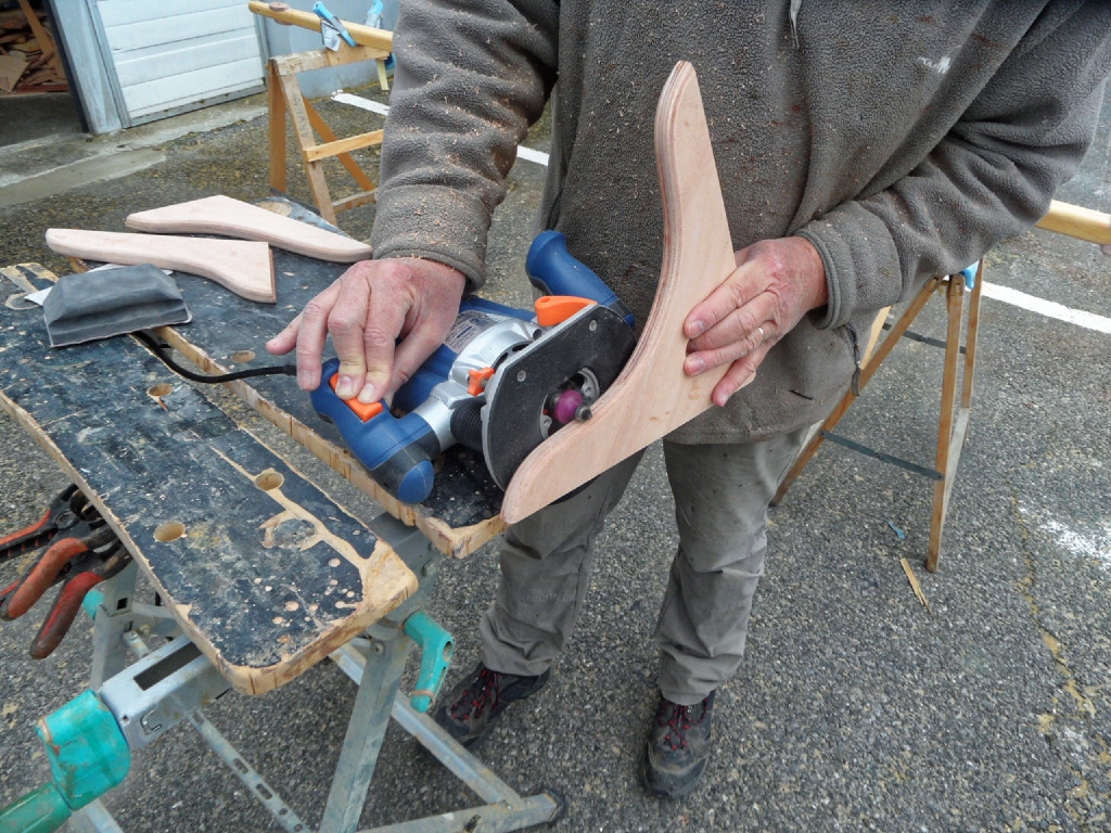 J'arrondis les arêtes de la guirlande à la défonceuse, sur laquelle j'ai monté une fraise en quart de rond. En principe, on n'utilise pas une défonceuse de cette façon, c'est dangereux et je ne recommande absolument pas cette méthode. 